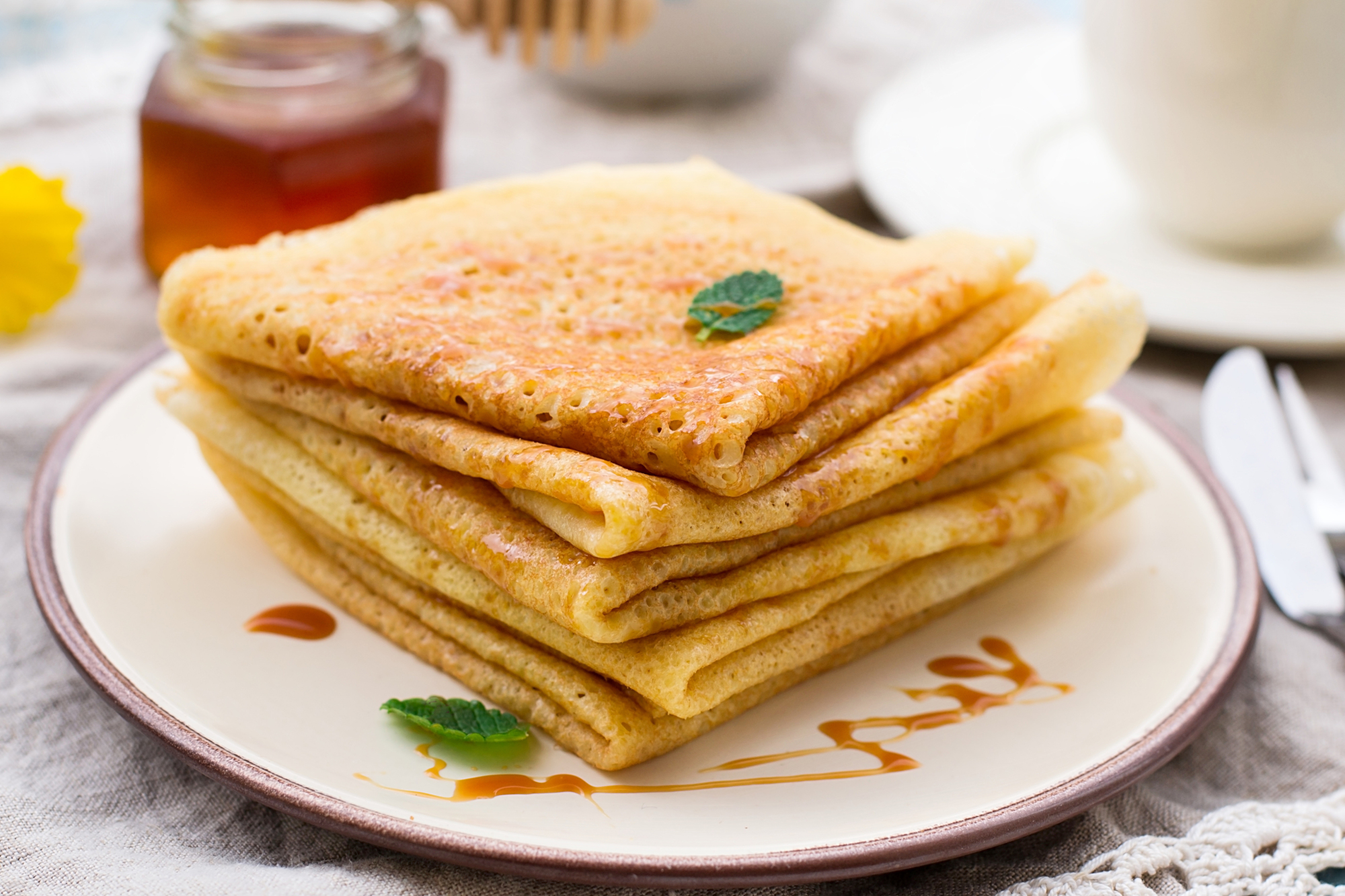 Stack of thin pancakes crepes with caramel toffee topping