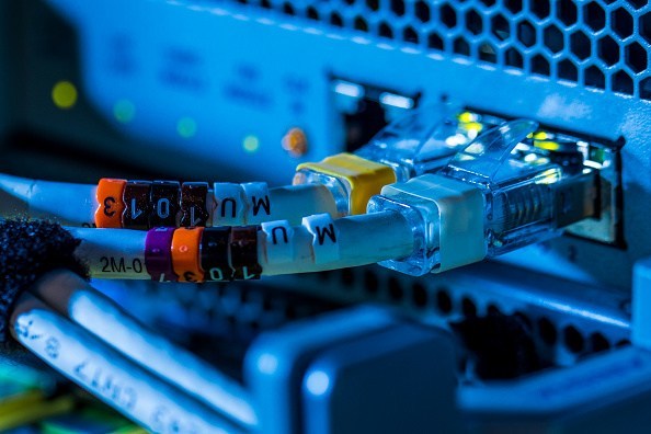 Clip on cable markers sit around network cables inside a communications room at an office in London, U.K., on Monday, May 21, 2018. The Department of Culture, Media and Sport will work with the Home Office to publish a white paper later this year setting out legislation, according to a statement, which will also seek to force tech giants to reveal how they target abusive and illegal online material posted by users. Photographer: Jason Alden/Bloomberg via Getty Images