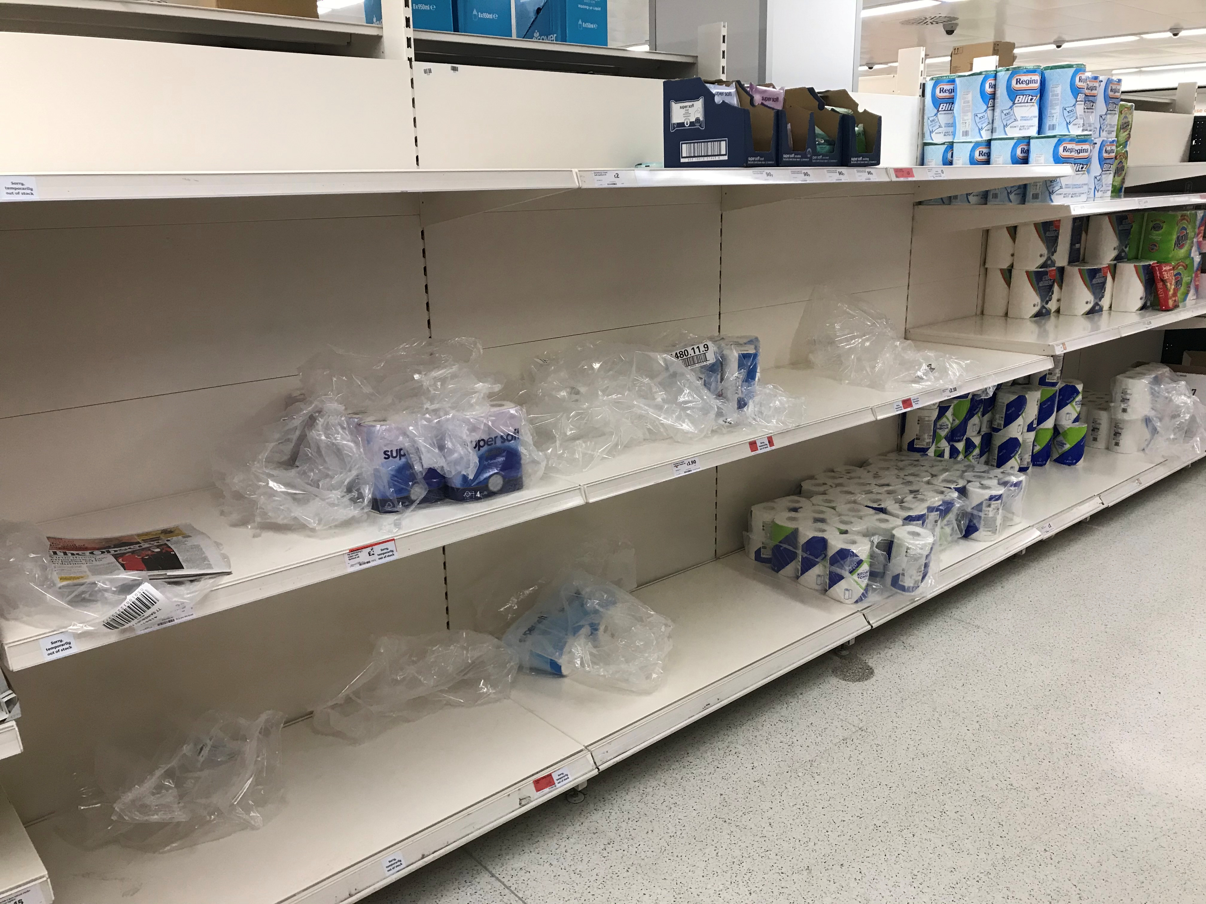 Toilet paper and kitchen rolls are seen for sale on shelves in a supermarket, Harpenden, Britain March 8, 2020.  REUTERS/Peter Cziborra