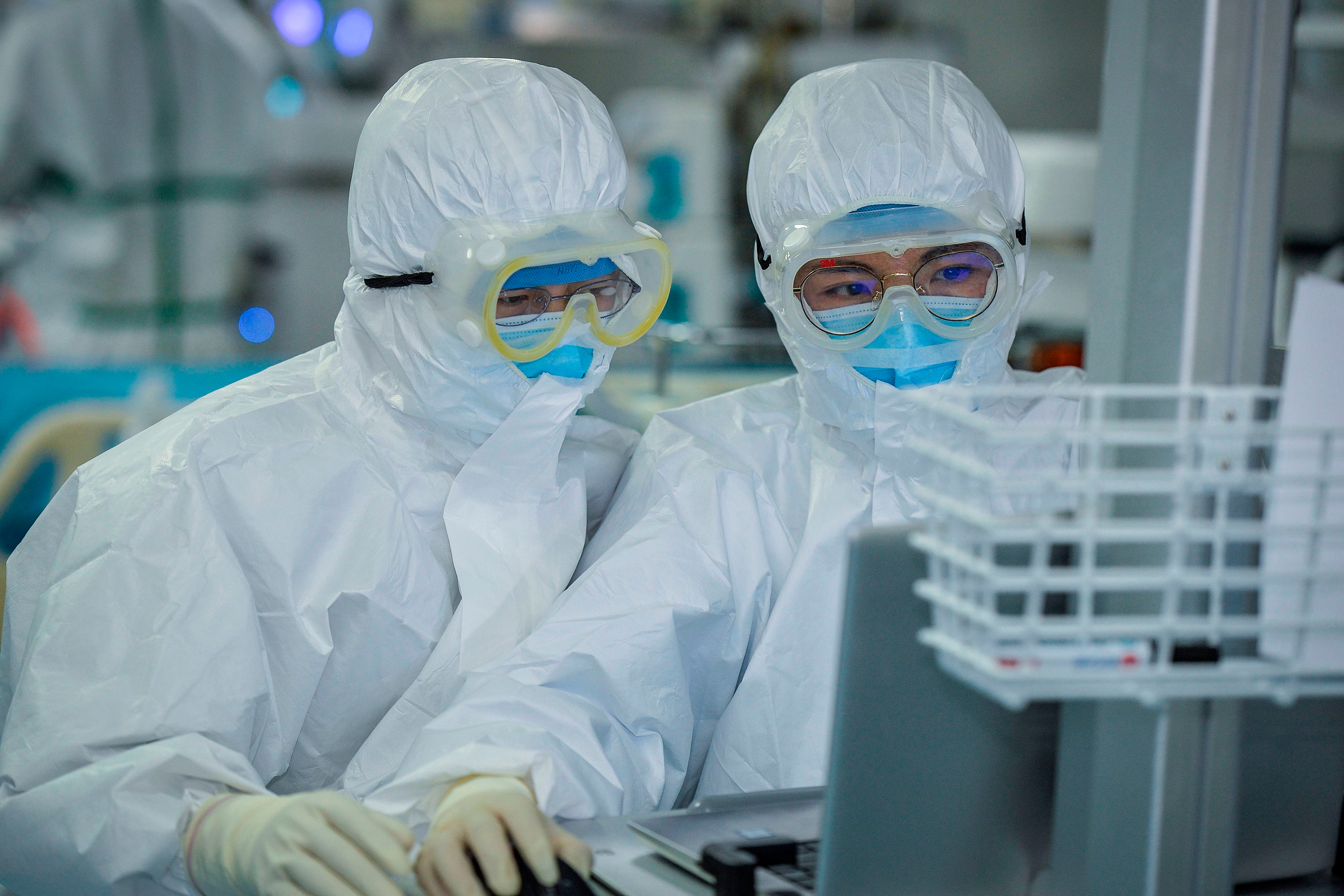 This photo taken on February 24, 2020 shows doctors working as they treat patients infected by the COVID-19 coronavirus at a hospital in Wuhan in China's central Hubei province. - The new coronavirus has peaked in China but could still grow into a pandemic, the World Health Organization warned, as infections mushroom in other countries. (Photo by STR / AFP) / China OUT (Photo by STR/AFP via Getty Images)