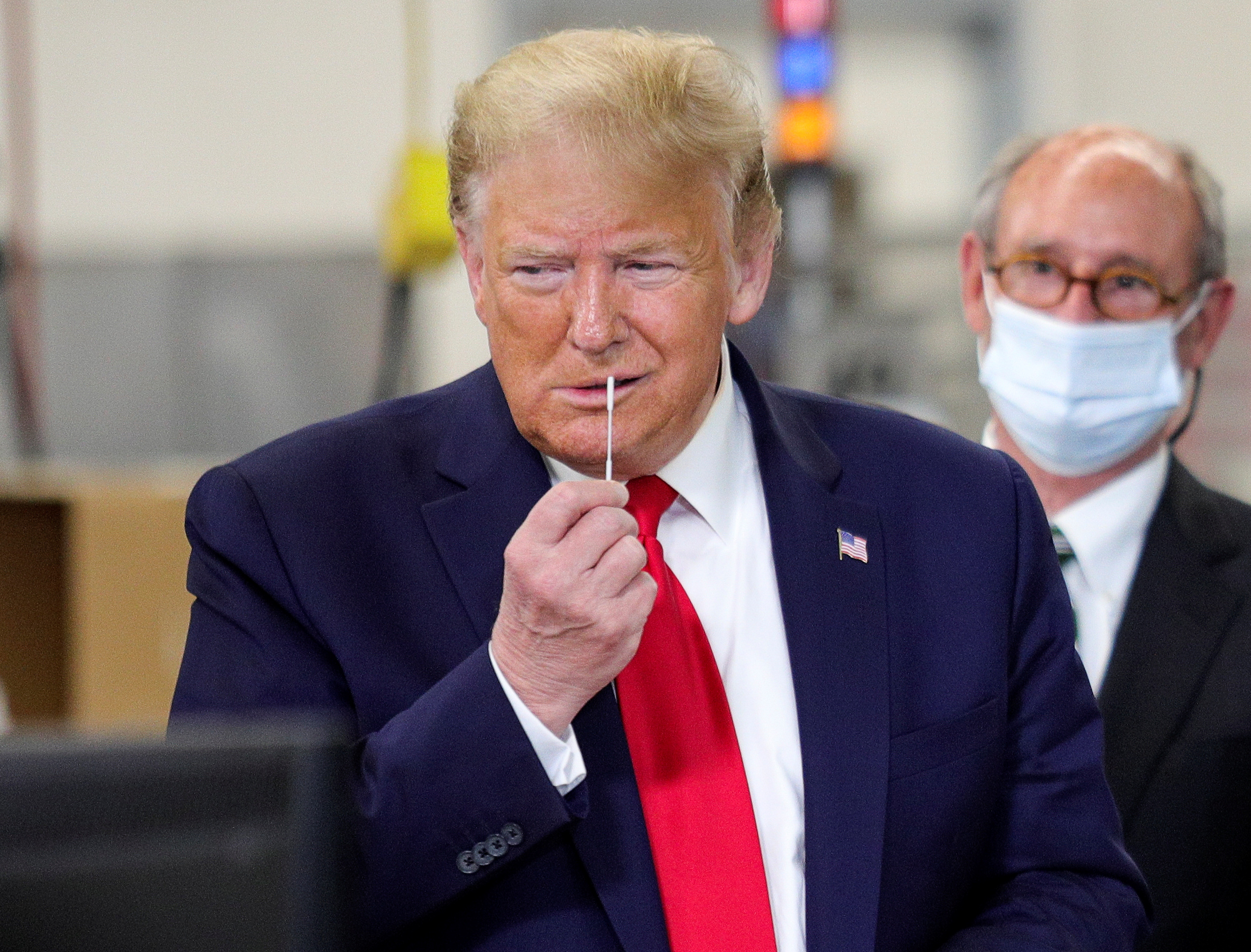 U.S. President Donald Trump pretends to insert a nose swap as he tours Puritan Medical Products manufacturing facility, where swabs for coronavirus disease (COVID-19) tests are made, in Guilford, Maine, U.S., June 5, 2020. REUTERS/Tom Brenner?